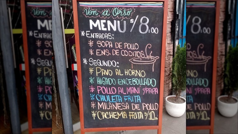 A chalkboard sign in Peru featuring the daily menu.
