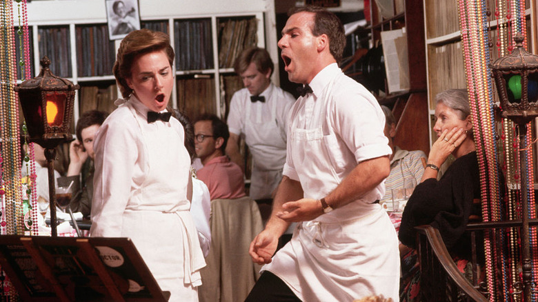 Male and female restaurant servers dressed in black bow ties singing opera at Victor's