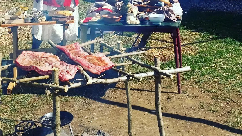 A smoking boucan, with roasting meat.