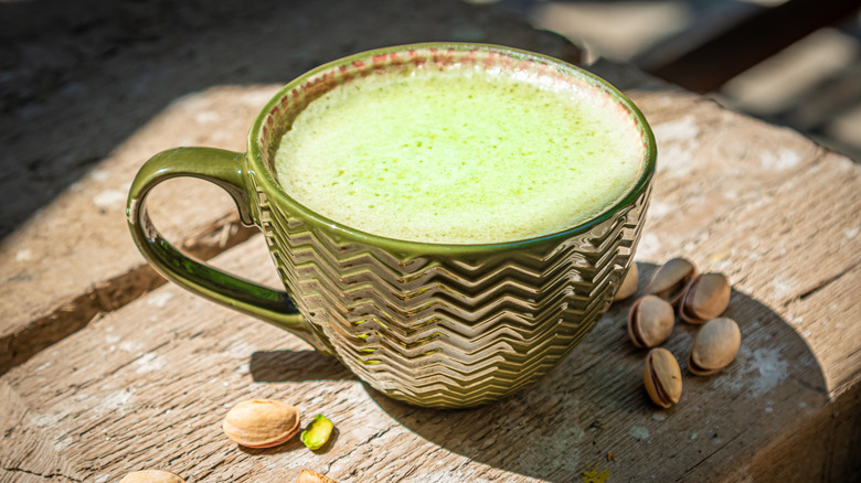 A cup of coffee with pistachios