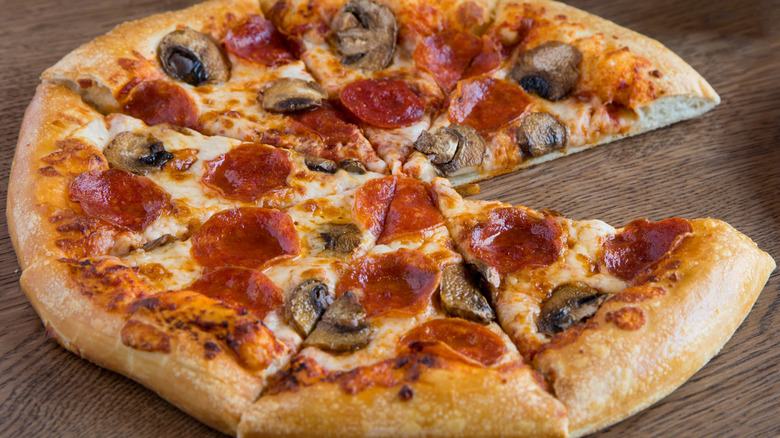 A Pizza Hut hand-tossed pizza with pepperoni and mushrooms.
