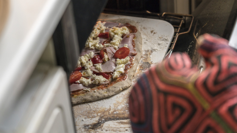 a pizza being baked on pizza stone