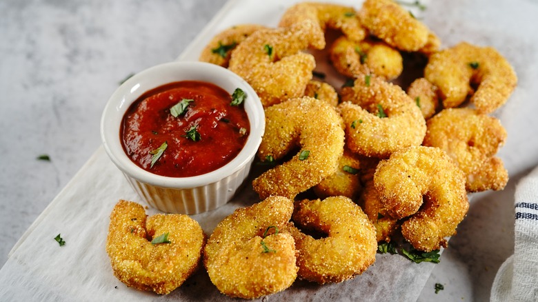 Popcorn shrimp with a bowl of cocktail sauce