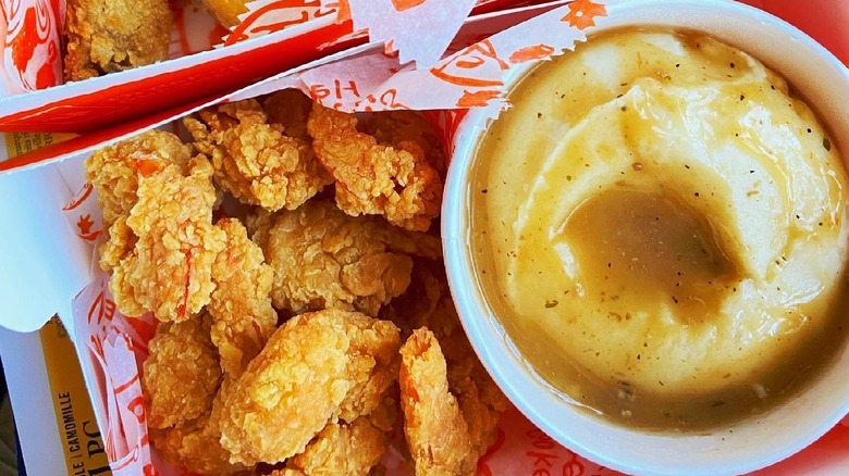 a serving of fried chicken and mashed potatoes with gravy