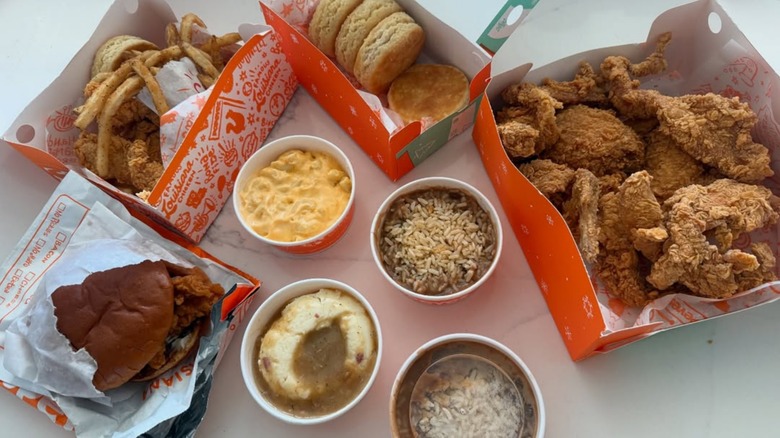 A slew of sides from Popeyes, including fries, mac and cheese, red beans and rice, and biscuits