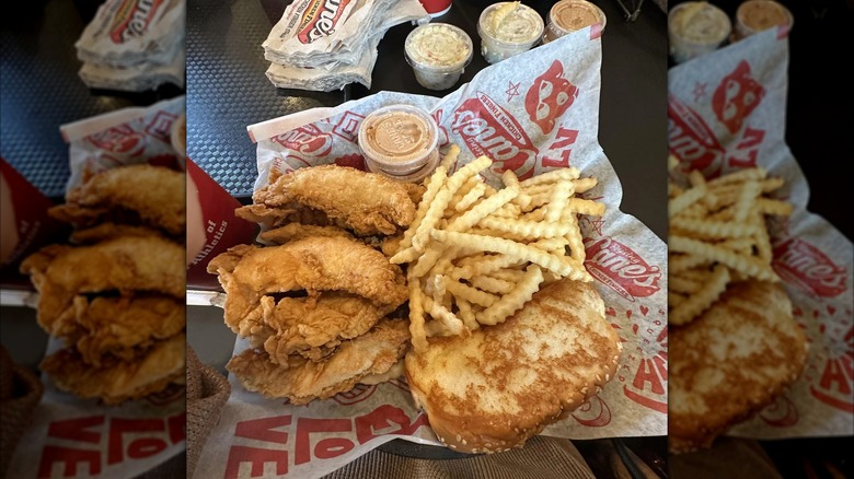 A basket of Raising Cane's chicken fingers, fries, and Texas toast.
