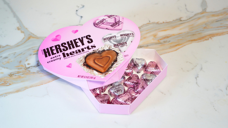 An open heart-shaped box of Hershey's Extra Creamy Milk Chocolate