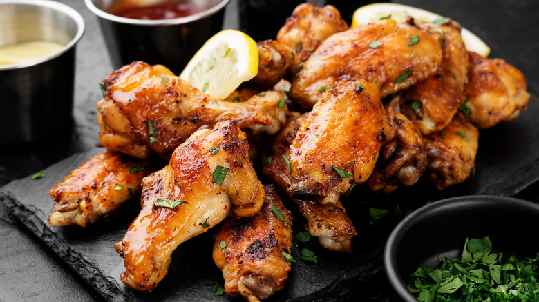 Pile of chicken wings on slate board