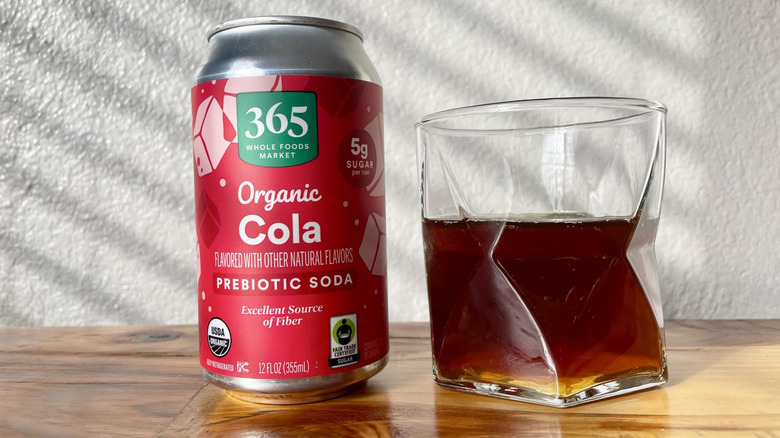 Can and glass of 365 by Whole Foods Market Organic Cola on a wooden table