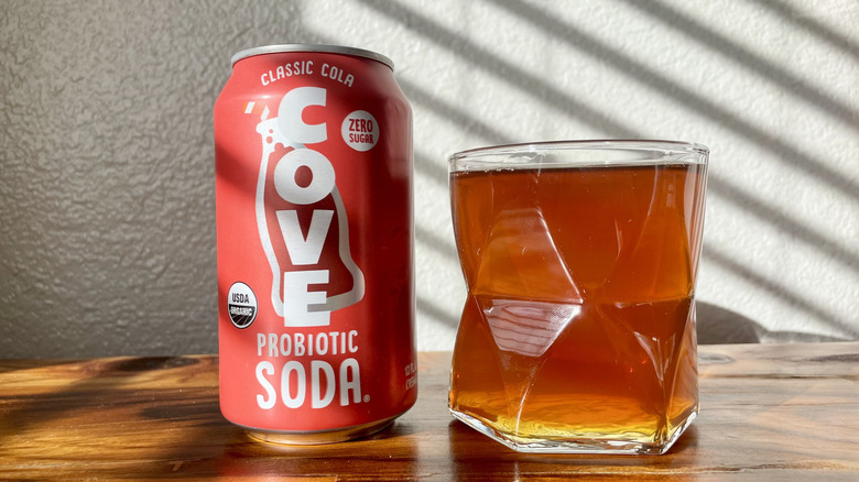 A can and glass of Cove Classic Cola on a wooden table