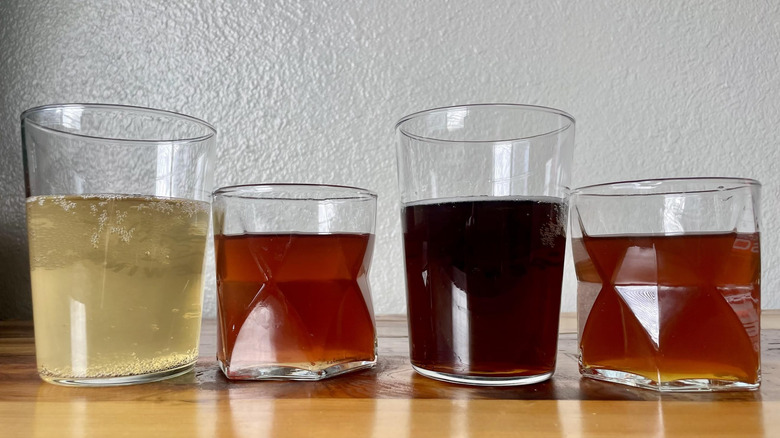 Four glasses full of various prebiotic colas of different colors