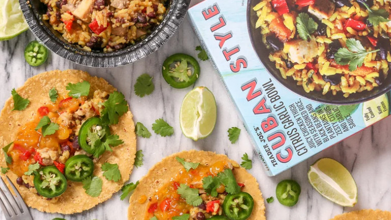 Cuban Style Garlic Citrus Bowl package next to two tacos, fresh lime and cilantro