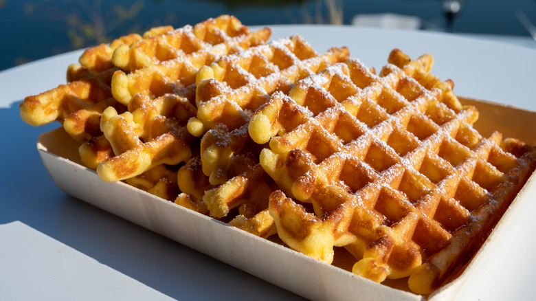 Waffles sitting on cardboard plate