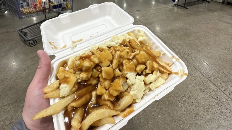 Order of poutine smothered with cheese curds and gravy from Costco Canada food court