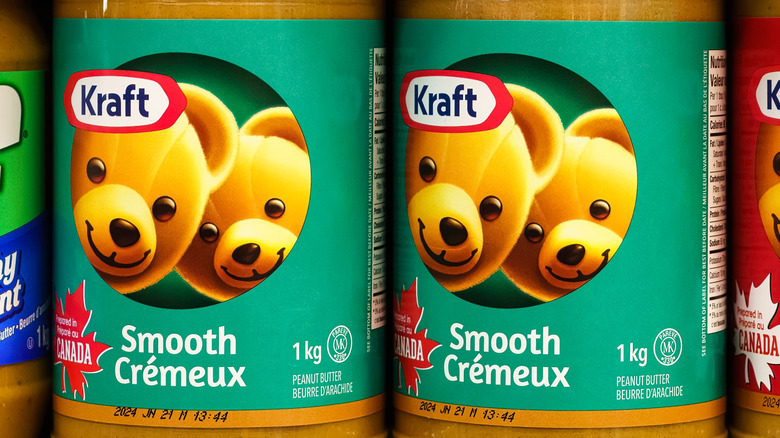 Jars of Kraft peanut butter on a store shelf