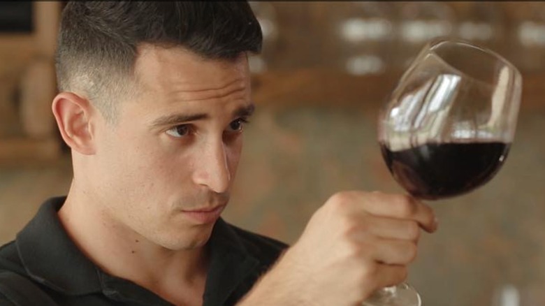 Alexander Simone with a glass of wine