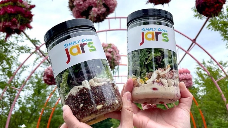 Hands holding two Simply Good Jars