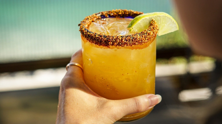 Someone holds a tamarind margarita.