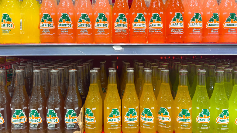 Shelf containing many Jarrito sodas.