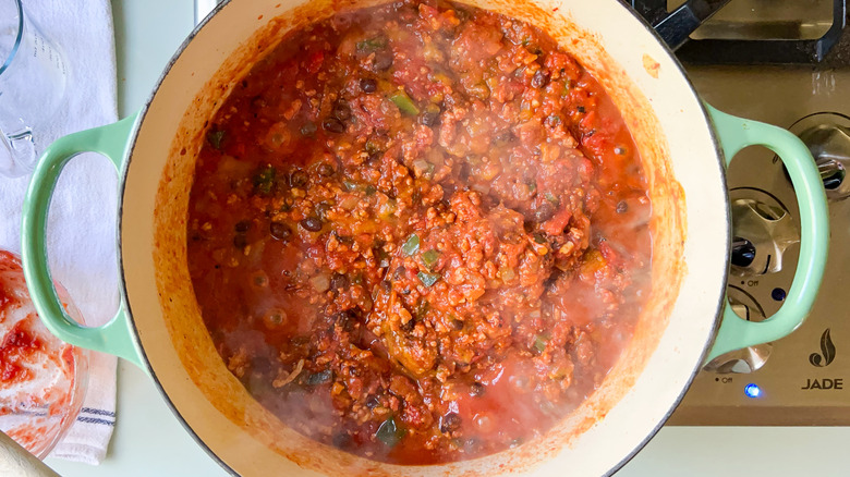Pumpkin and turkey chili ingredients in pot on stove