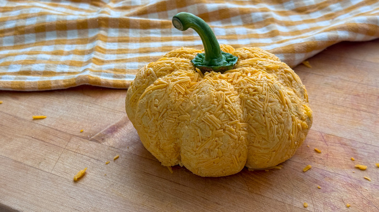 Pumpkin cheese ball on wooden board