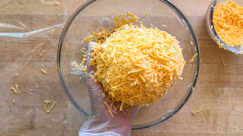 hand holding coated cheese ball