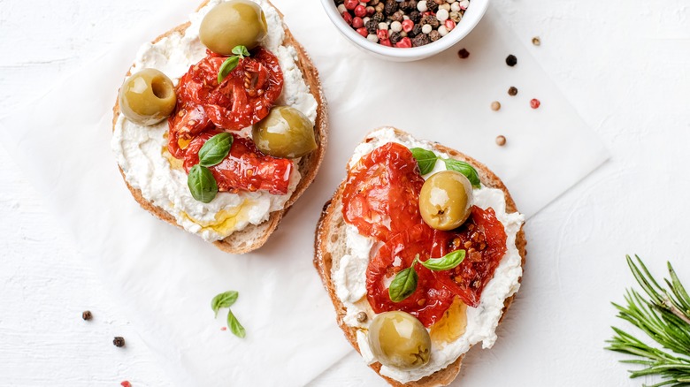 ricotta cheese toast with olives and sun-dried tomato