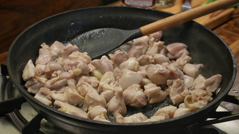 chicken cubes sauteeing in skillet