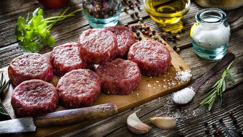burger patties displayed alongside array of spices