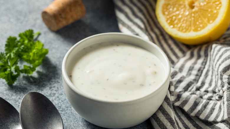 Homemade ranch dressing with herbs in a jar