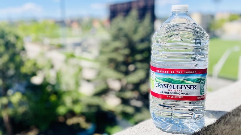 Large bottle of Crystal Geyser on outdoor ledge