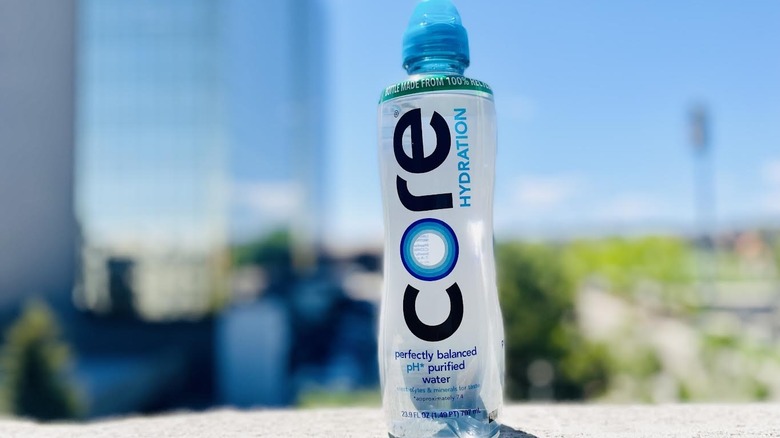 Bottle of Core Hydration water on outdoor ledge