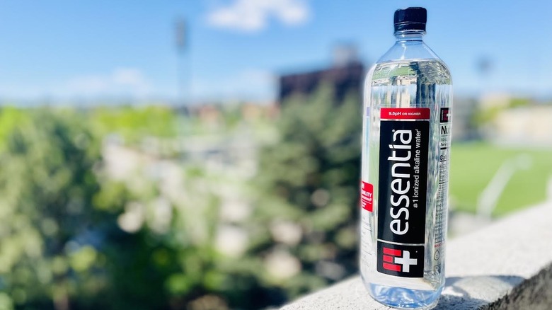 Bottle of Essentia Ionized Drinking Water on outdoor ledge