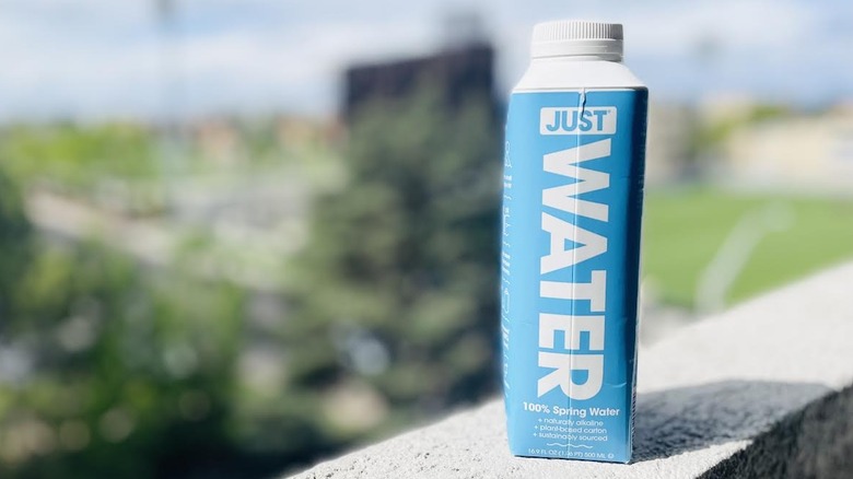 Carton of Just Water on outdoor ledge