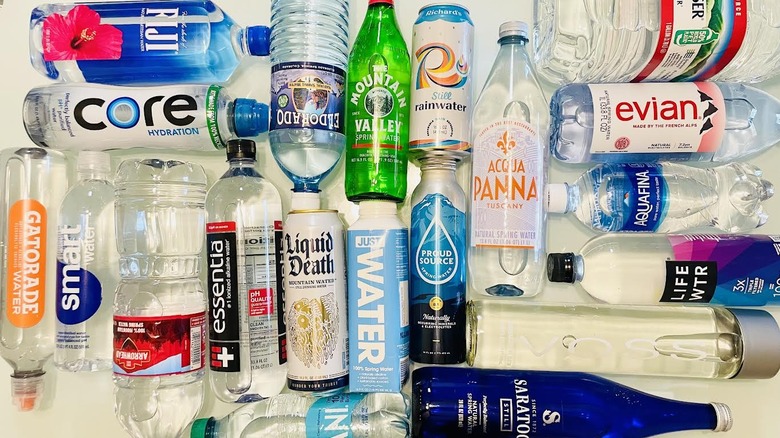 Overhead view of various bottled waters lying on table
