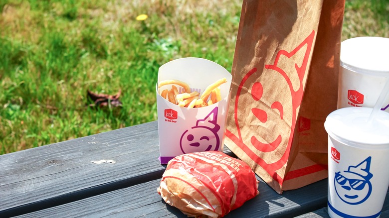 A Jack in the Box meal with fries, a burger and two drinks