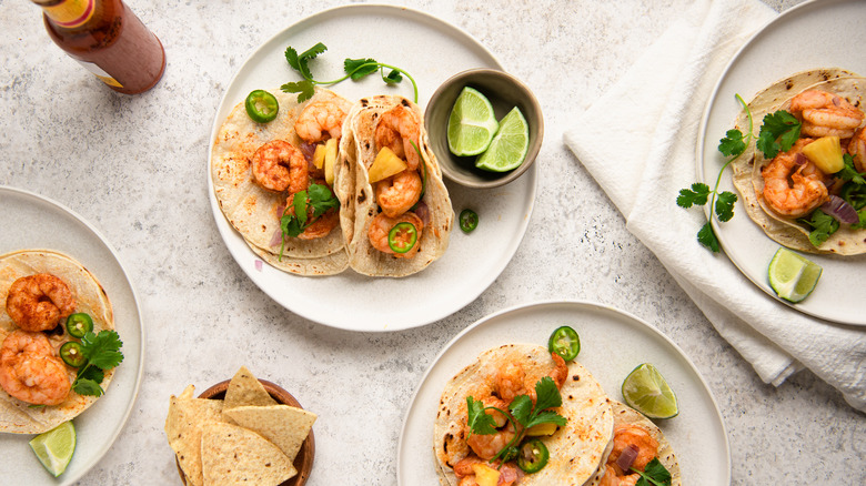 Flat lay photo of shrimp tacos with limes