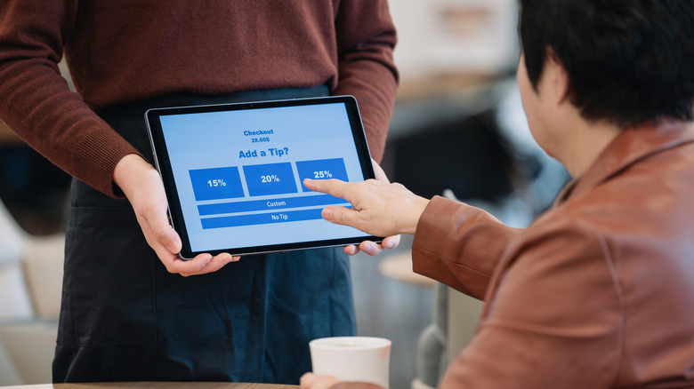 customer selecting tip amount on a tablet screen