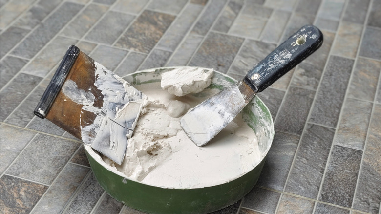 A close-up of joint compound and a trowel