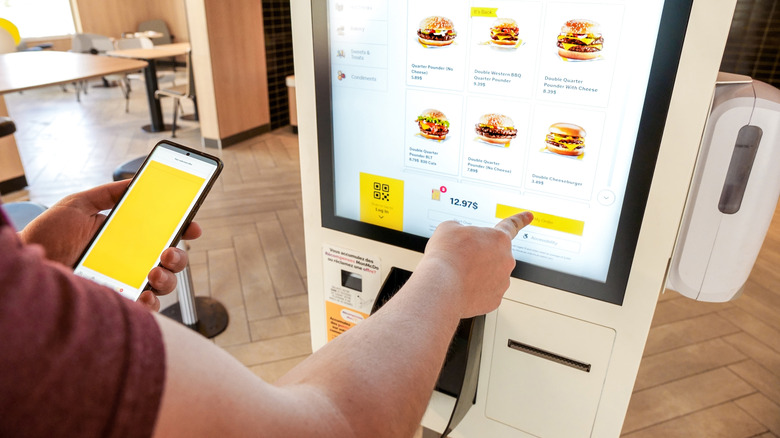 A customer places an order at a McDonald's digital kiosk
