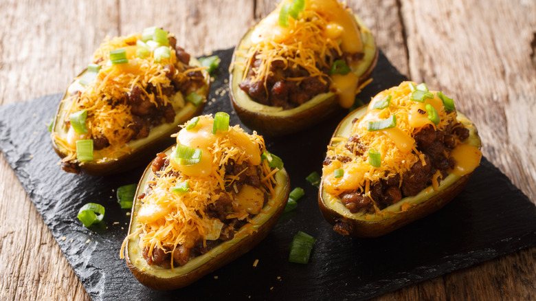 avocados stuffed with ground beef on slate