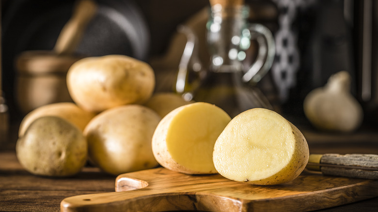 halved raw potatoes on cutting board
