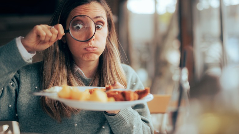 Food critic inspecting dish in restaurant