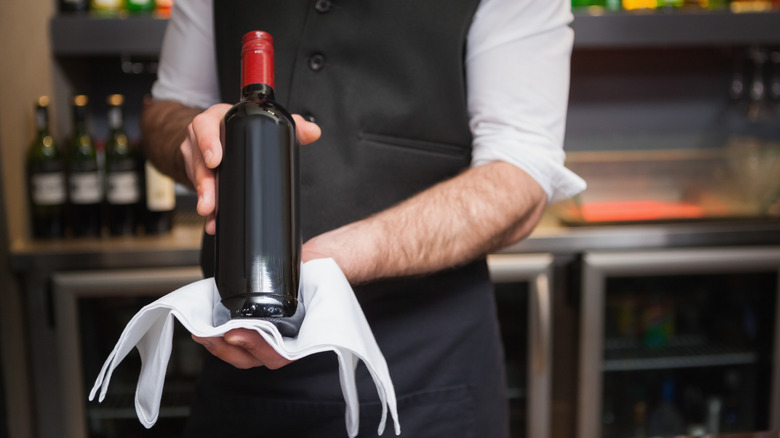Waiter holding a bottle of wine