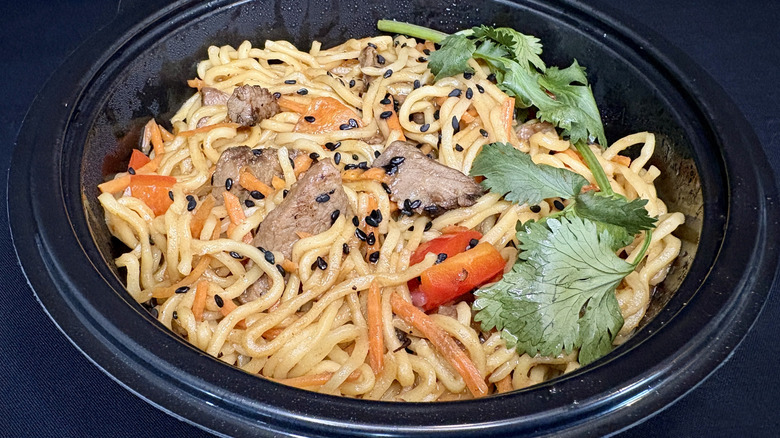 sesame steak ramen in bowl on black background
