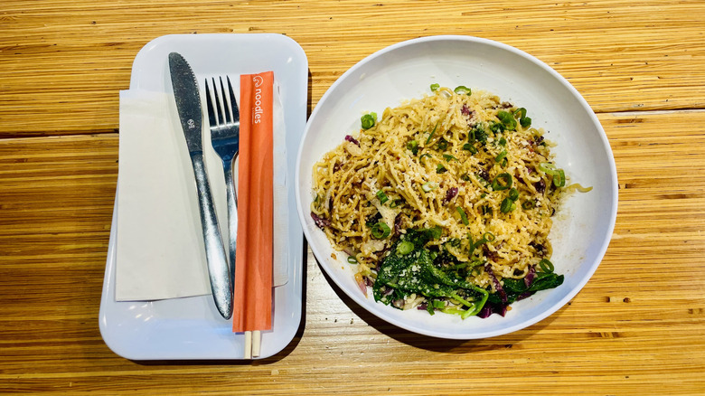 Bowl of Noodles & Co. Chili Garlic Ramen with utensils