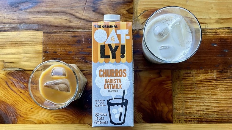 Overhead view of Oatly Churros Oatmilk with glasses of it on ice