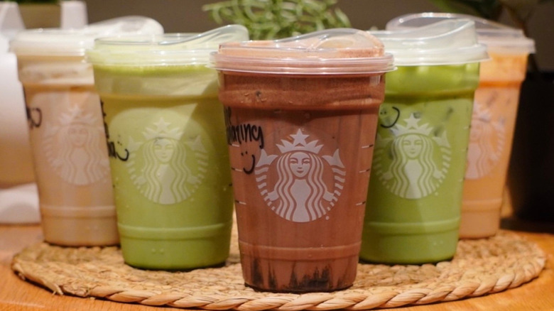 Protein Cold Foam Drinks and Protein Lattes on a woven placemat in front of plants
