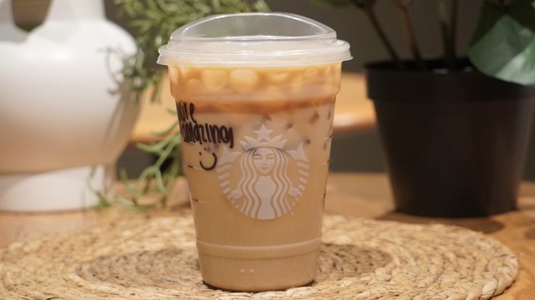Sugar-Free Vanilla Protein Latte on a woven placemat in front of plants