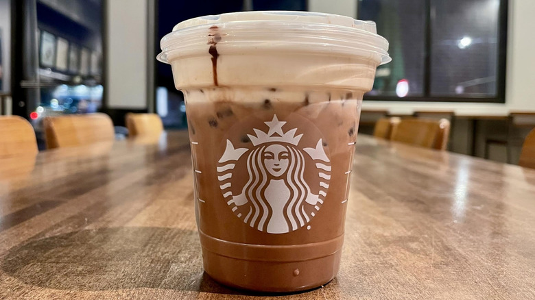 Starbucks new Iced Dubai Chocolate Mocha on wooden table inside store